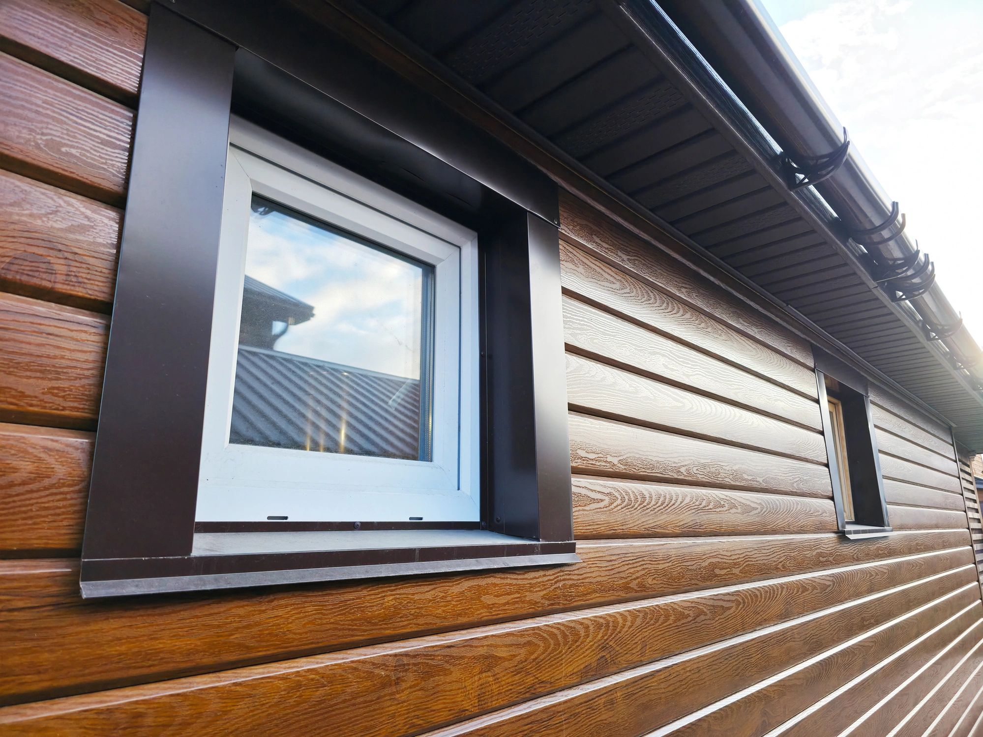 Exterior siding detail near a bright window